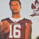 Football player holding ball in Tigers jersey