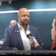 Man being interviewed by reporter indoors
