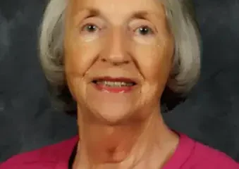 Portrait of smiling elderly woman in pink top