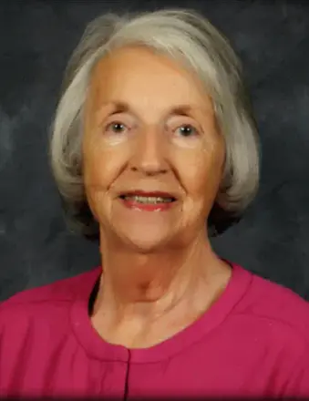 Portrait of smiling elderly woman in pink top