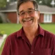 Smiling man in red shirt outdoors