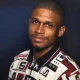 Portrait of man in patterned shirt against dark background