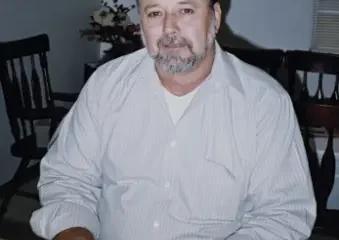 Man sitting at wooden table indoors