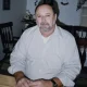 Man sitting at wooden table indoors