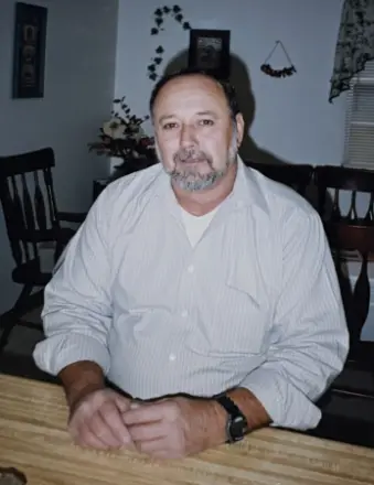 Man sitting at wooden table indoors