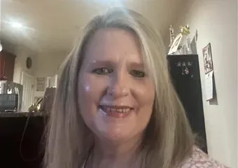 Smiling woman with blonde hair indoors