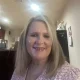 Smiling woman with blonde hair indoors
