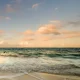 Ocean waves at sunset with pastel sky