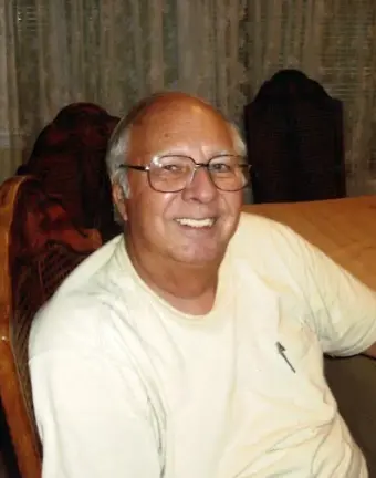Smiling elderly man wearing glasses indoors