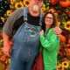 Man and woman posing before fall pumpkin display