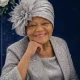 Elegant elderly woman in silver outfit and hat