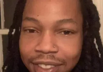 Close-up portrait of smiling person with long twists