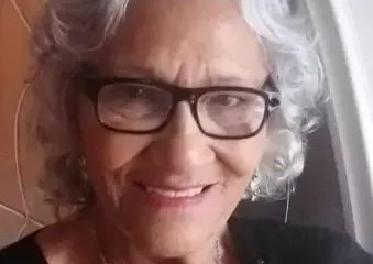 Smiling elderly woman with gray hair and glasses
