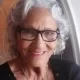 Smiling elderly woman with gray hair and glasses