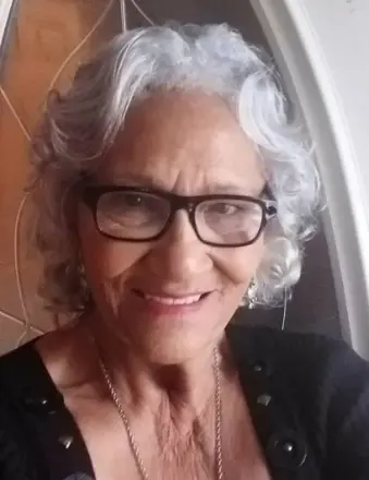 Smiling elderly woman with gray hair and glasses