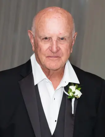 Elderly man in tuxedo with boutonniere