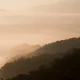 Misty mountain layers at sunrise