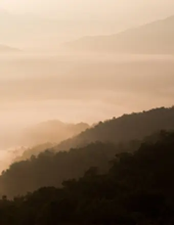 Misty mountain layers at sunrise