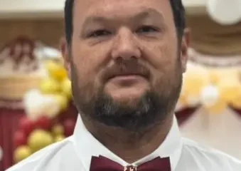 Man wearing red bow tie and white shirt