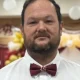 Man wearing red bow tie and white shirt