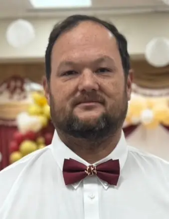Man wearing red bow tie and white shirt