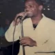 Man singing into microphone indoors