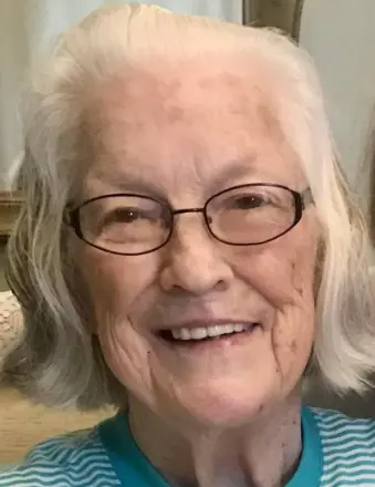 Smiling elderly woman with white hair and glasses