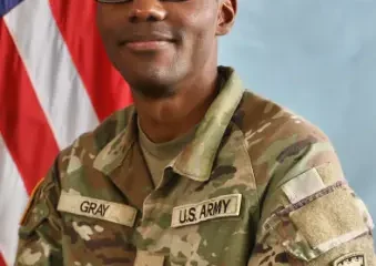 U.S. Army soldier in uniform with flag