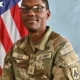 U.S. Army soldier in uniform with flag