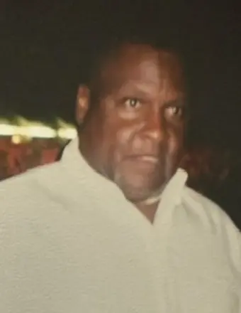 Man in light shirt against dark background