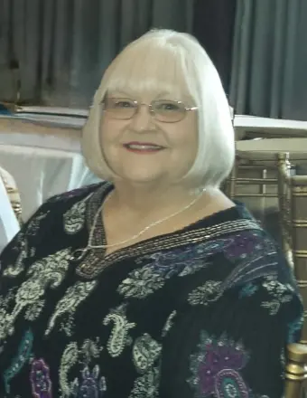 Smiling elderly woman with white bob haircut and glasses