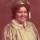 Smiling graduate in cap and gown portrait