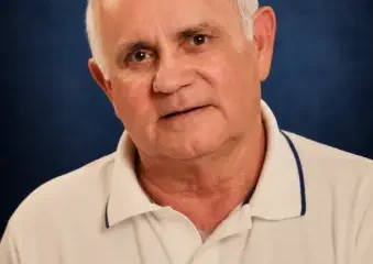 Portrait of older man in white polo shirt