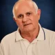 Portrait of older man in white polo shirt