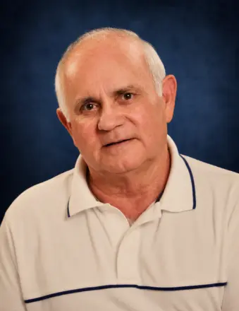 Portrait of older man in white polo shirt