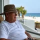 Older man relaxing on beachside balcony
