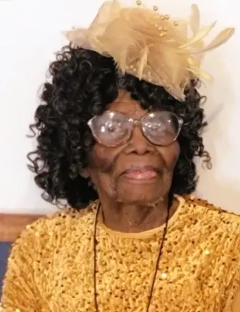 Elderly woman in yellow dress and decorative hat