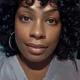 Close-up portrait of woman with curly hair