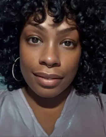 Close-up portrait of woman with curly hair