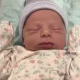 Sleeping newborn baby in striped knit hat