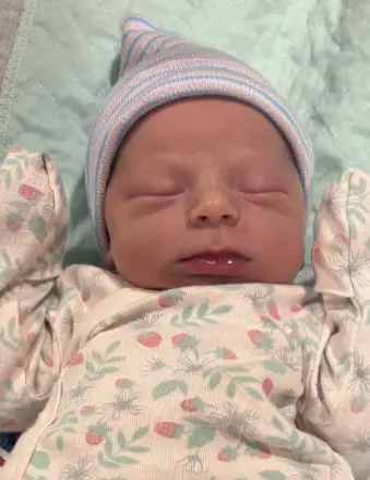 Sleeping newborn baby in striped knit hat