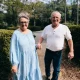 Smiling older couple walking hand in hand outdoors