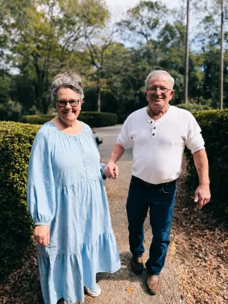 Smiling older couple walking hand in hand outdoors