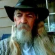 Older man with long gray beard wearing cowboy hat