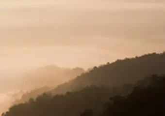 Misty mountain layers at sunrise