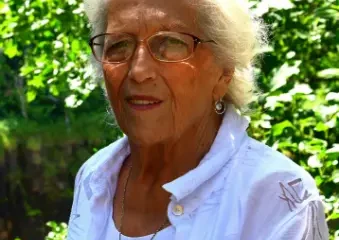 Elderly woman with white hair outdoors