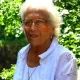 Elderly woman with white hair outdoors