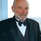 Older man in tuxedo with gray beard