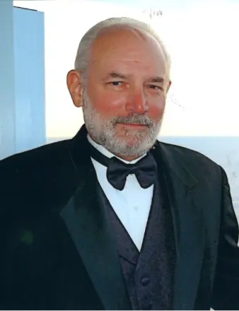 Older man in tuxedo with gray beard