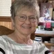 Smiling elderly woman wearing glasses indoors